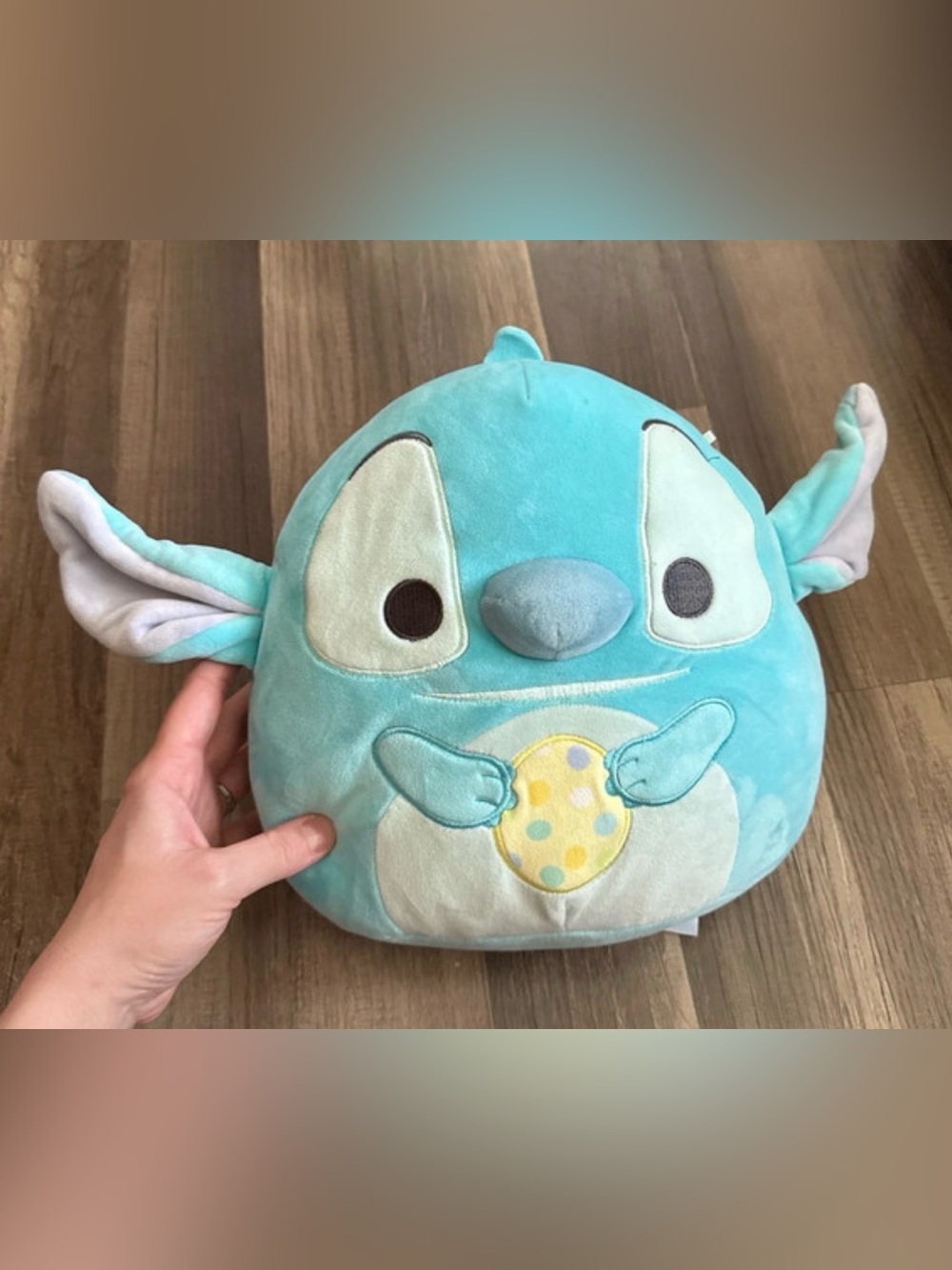 10-inch Squishmallows Disney Easter Stitch plush toy holding a spotted egg.